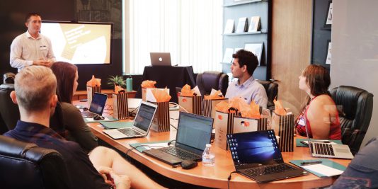 man presenting to several people