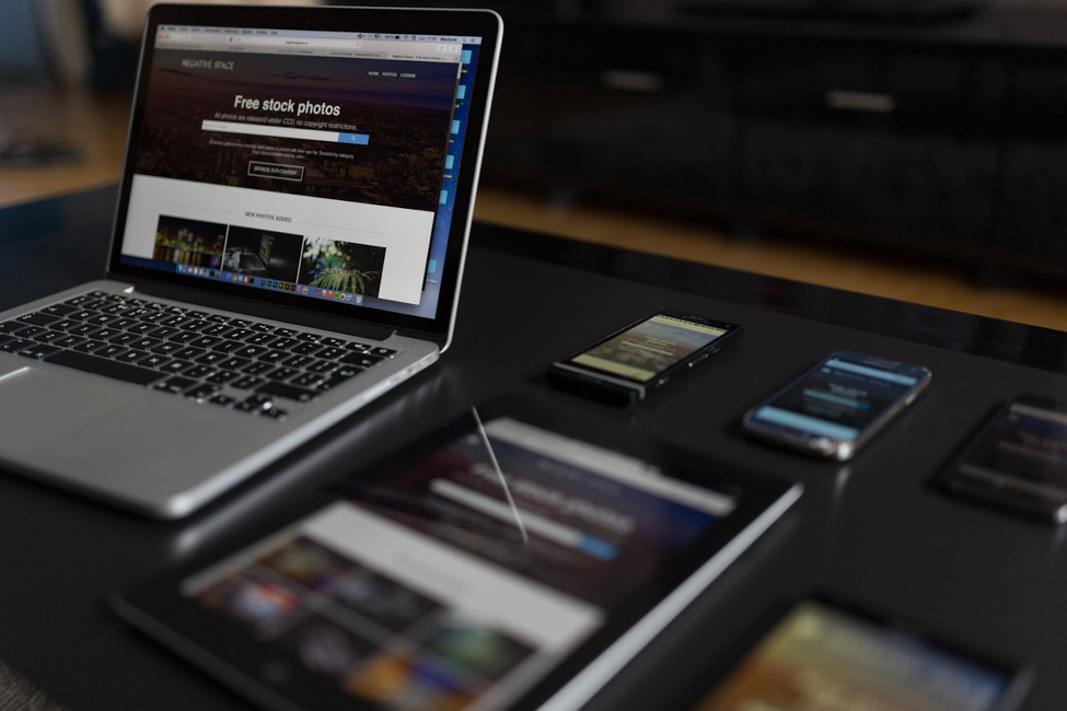 Laptop, tablet and two phones on a table